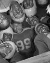 <p>The Bethune-Cookman College football team gathered in a huddle in January 1943 in Daytona Beach, Florida — another famous image taken by Parks.</p>