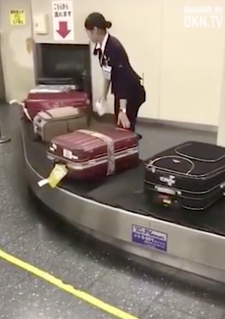 The luggage handler can be seen keeping a close eye on the bags in front of her. Photo: DKN.TV