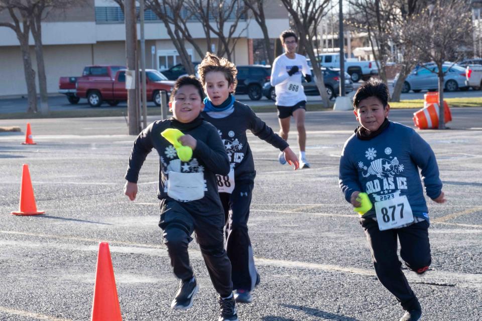 A group of Cactus Elementary School Students sprint to the finish line Saturday at the Cold As Ice run in Amarillo.