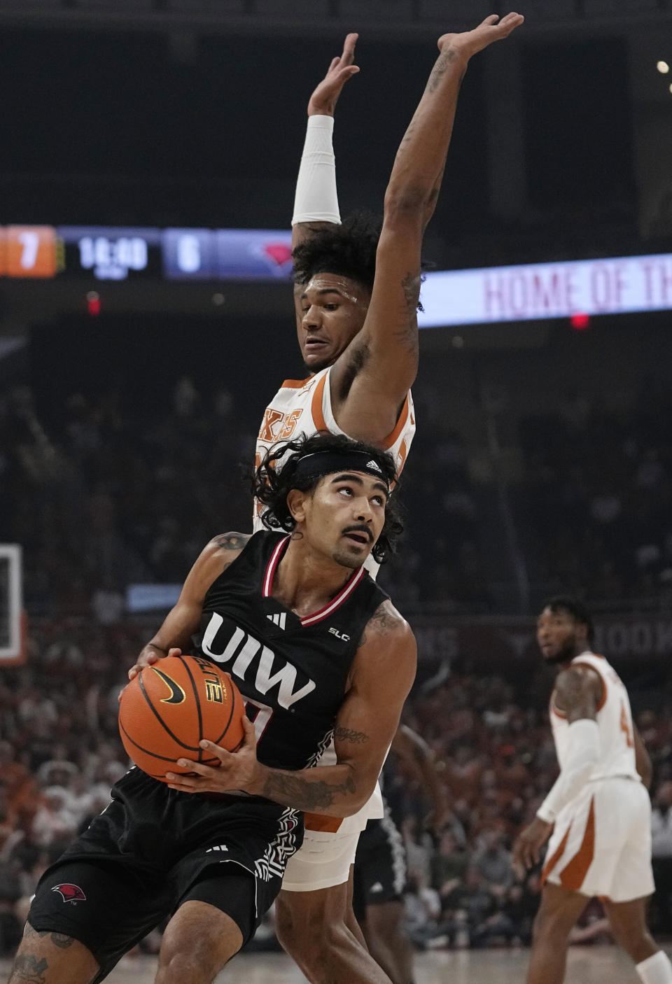 Incarnate Word guard Sky Wicks (00) looks to shoot past Texas forward Dillon Mitchell (23) during the first half of an NCAA college basketball game, Monday, Nov. 6, 2023, in Austin, Texas. (AP Photo/Eric Gay)