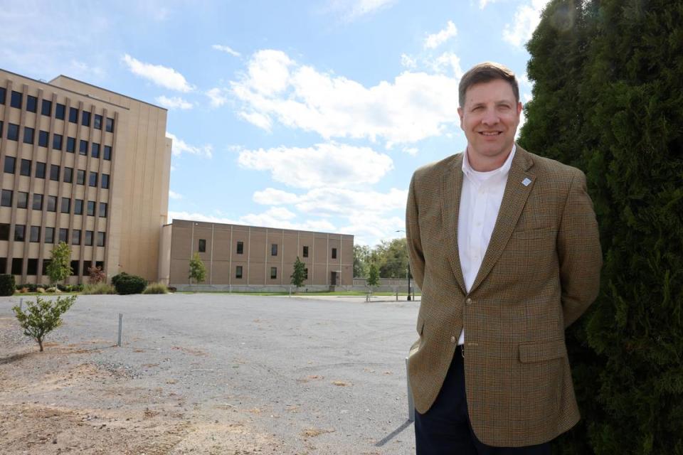 Todd Leahy, executive director with The Arts Center at Fountain Park, stands in the gravel lot across from Fountain Park where the arts center will be built.