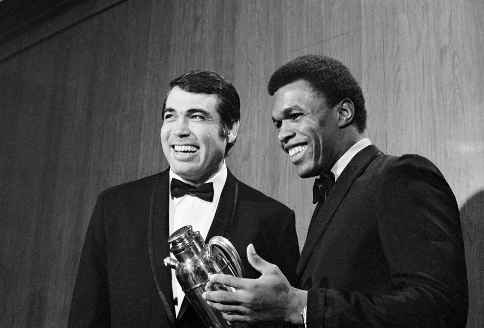 FILE - Joe Kapp of Minnesota Vikings, left, and Chicago Bears running back Gale Sayers receive honors at the Wisconsin Football Writers Association dinner in Milwaukee, Feb. 15, 1970. Sayers was named Comeback Player of the Year and Kapp received the Vince Lombardi award at the event. Kapp, the tough quarterback who led the Minnesota Vikings to their first Super Bowl and California to its last Rose Bowl, has died. He was 85. Cal confirmed that Kapp died on Monday, May 8, 2023. (AP Photo/Paul Shane, File)