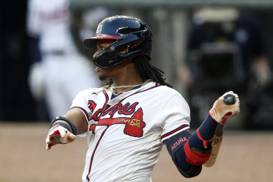 Atlanta Braves' Ronald Acuña Jr. follows through on an RBI double during the second inning of the team's baseball game against the New York Mets on Saturday, Aug. 1, 2020, in Atlanta. (AP Photo/John Bazemore)