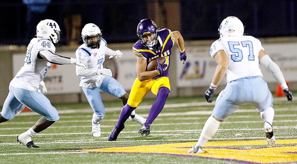 Ashland University's Logan Bolin (13) carries the ball after making a catch as Northwood University's Mbaimba Tunkara (44) and Tegan Kogler (57) converge for the tackle during college football action at Jack Miller Stadium Saturday, Oct. 1, 2022. TOM E. PUSKAR/ASHLAND TIMES-GAZETTE