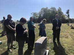 Montgomery County First Deputy Coroner Alexander Balacki (far right) stands with members of Roscoe Fellman's family as his ashes were interred on Sept. 25, 2019.