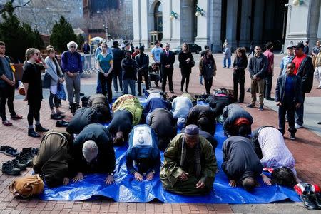 People take part in a prayer at one Saint Andrews Plaza in Lower Manhattan, New York, U.S. February 24, 2017. REUTERS/Eduardo Munoz