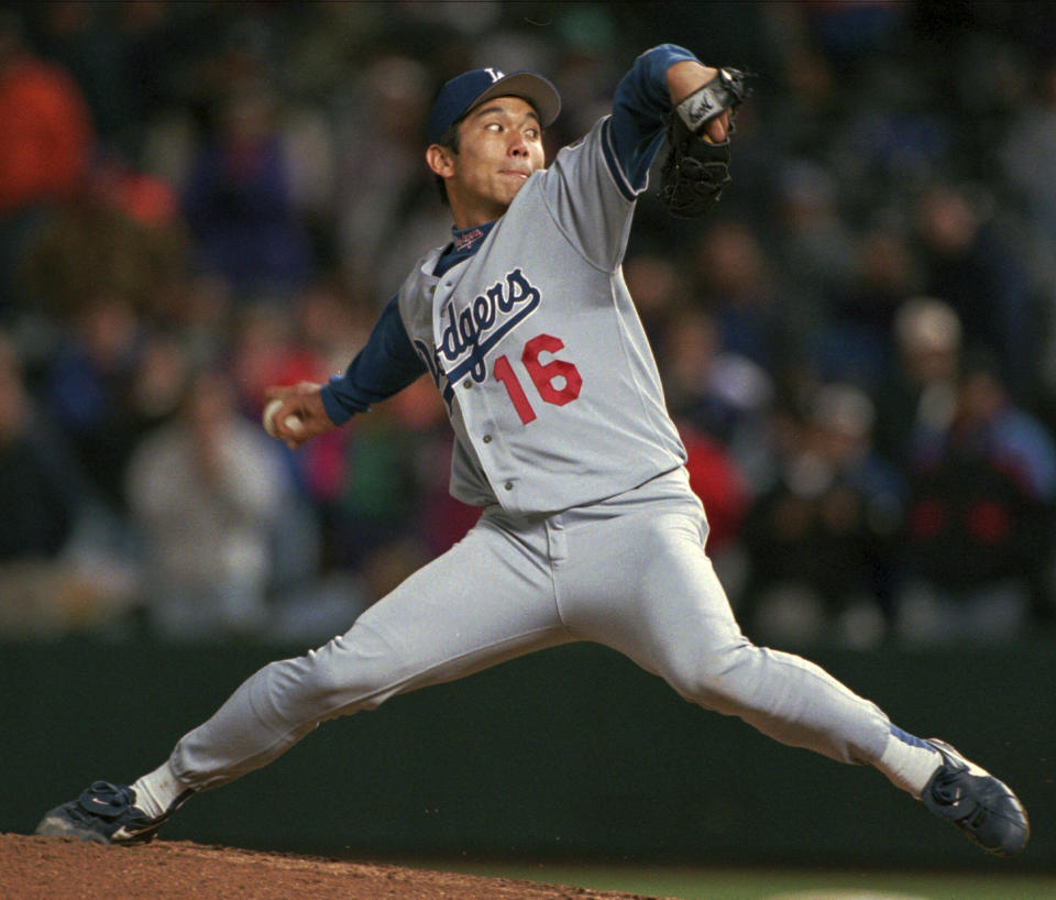 FILE - Los Angeles Dodgers starting pitcher Hideo Nomo delivers a pitch to Colorado Rockies batter Ellis Burks on the way to striking him out and notching a no-hit performance in the Dodgers' 9-0 victory in Denver's Coors Field late on Tuesday, Sept. 17, 1996. With full respect to Masanori Murakami, who played briefly with the San Fransisco Giants in 1964-65, Japan's odyssey in the Majors began with pitcher Hideki Nomo, the National League Rookie of the Year after joining the Dodgers in 1995. (AP Photo/David Zalubowski, File)