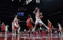 China's Yueru Li (14) grabs a rebound over Belgium's Marjorie Carpreaux (9) and Hanne Mestdagh (22) during a women's basketball game at the 2020 Summer Olympics, Monday, Aug. 2, 2021, in Saitama, Japan. (AP Photo/Eric Gay)