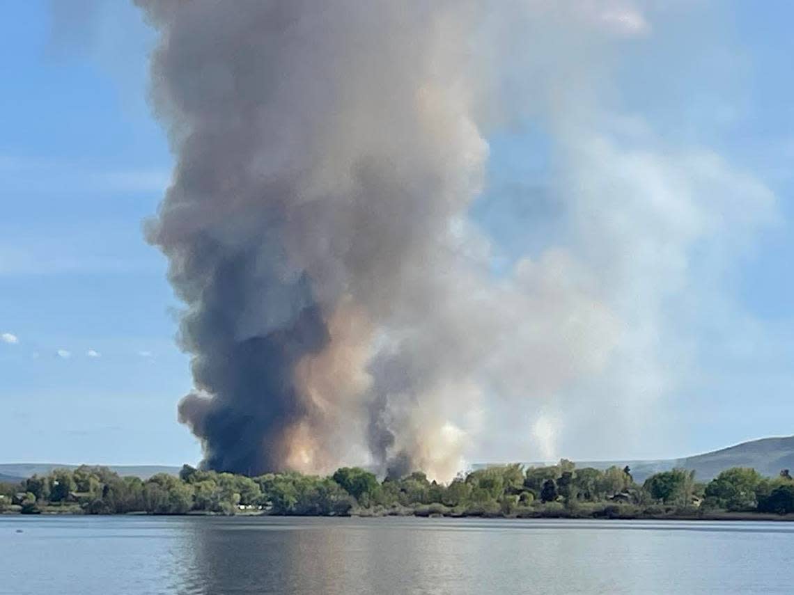 Plumes of smoke from a fire at the Lineage Logistics warehouse near the Columbia River in Finley and natural cover fires that started as embers spread could be seen for miles on April 21.