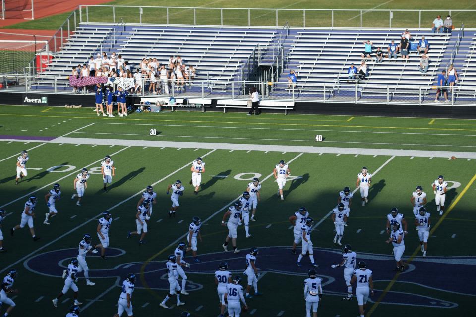 West Central football players and cheerleaders enter the field before the game against Sioux Falls Christian at USF Sports Complex in Sioux Falls, South Dakota on Friday, Sept. 1, 2023.