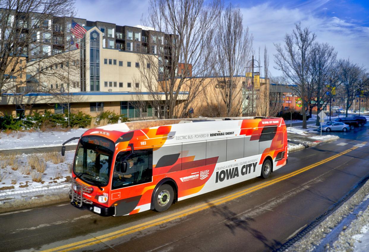 An Iowa City electric bus sits outside of City Hall on Washington Street downtown. The city plans to debut four new electric buses on Monday.