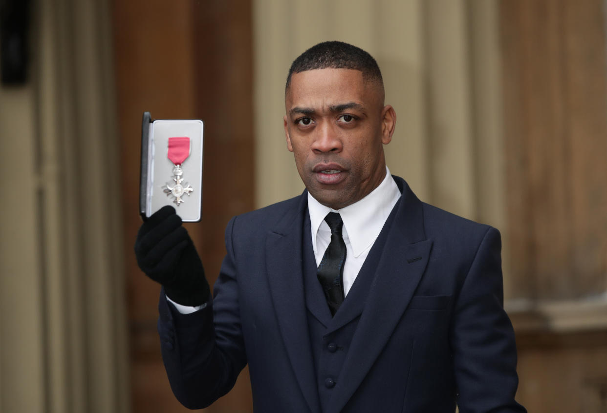 Musician Wiley, also known as Richard Cowie Jnr, holds his MBE following an investiture ceremony at Buckingham Palace, London.