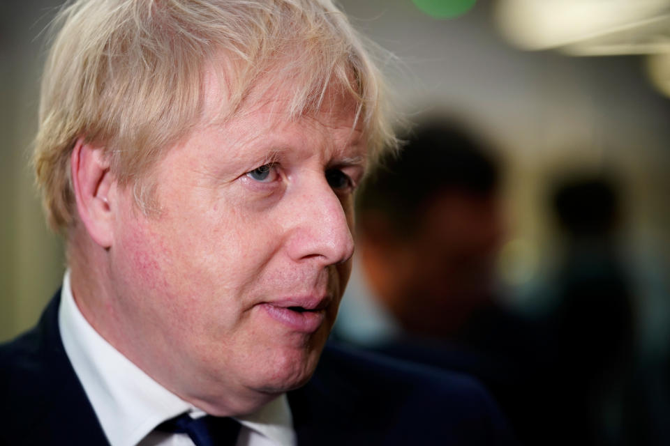 BOLTON, ENGLAND - NOVEMBER 16: Prime minister Boris Johnson speaks to staff and students at Bolton University chancellor's building in the aftermath of a huge blaze which damaged a block of student accommodation flats yesterday evening on November 16, 2019 in Bolton, England. A large fire broke out in a student accommodation block of flats known as The Cube yesterday evening resulting in two people being treated at the scene but no serious injuries. Around 200 firefighters tackled the fire which was brought under control in the early hours of this morning. Prime minister Boris Johnson broke from his election campaign trail to visit the scene. (Photo by Christopher Furlong/Getty Images)