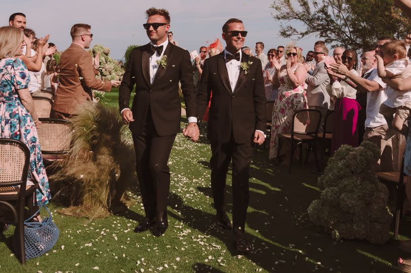 Scott and Sam walk down the aisle