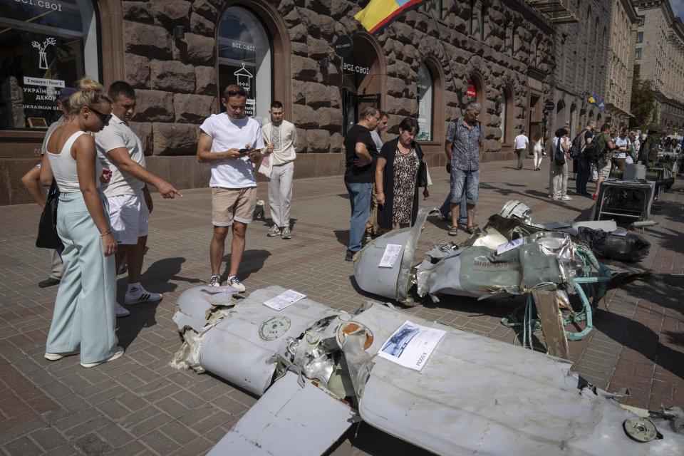 People look at fragments of Russian rockets which have been on display on the central Khreshchatyk boulevard in Kyiv, Ukraine, Thursday, Aug. 24, 2023, as Ukrainians mark Independence Day. (AP Photo/Efrem Lukatsky)