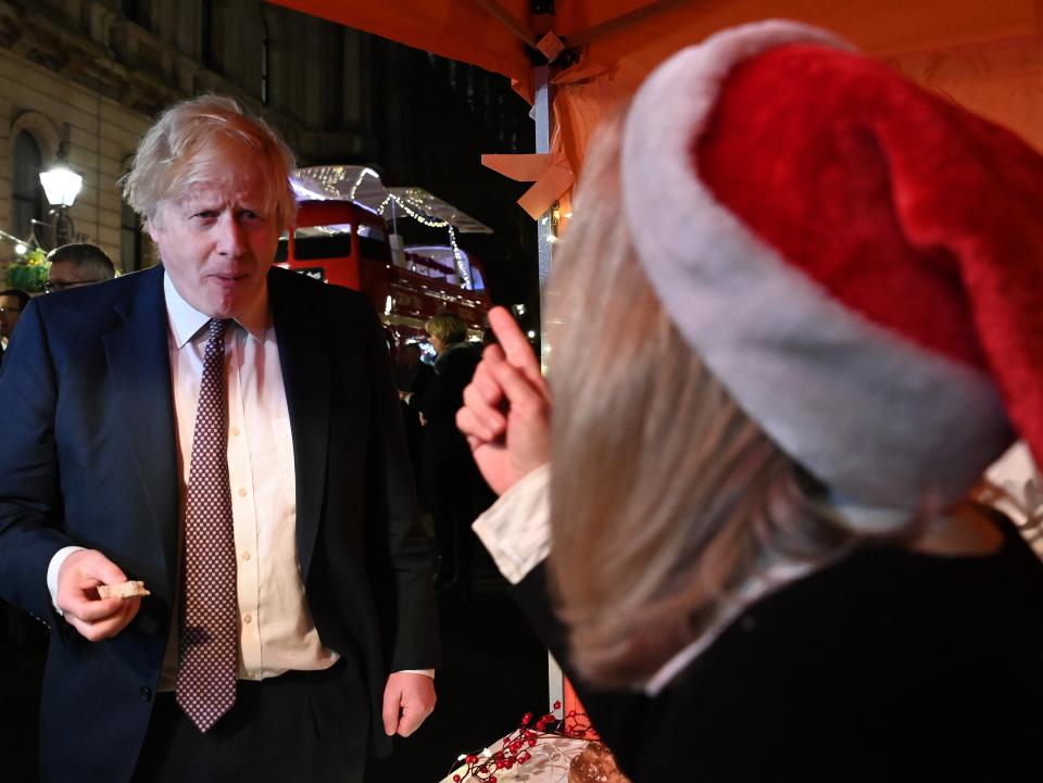 The PM visits a bread stall at a Christmas market outside No 10 earlier today (EPA)