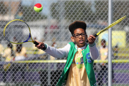 Cameron Campbell, 11, tries to catch a ball at a tennis workshop featuring U.S. Open Champion Sloane Stephens teaching tennis to 400 elementary students in Compton, California, U.S. April 12, 2018. REUTERS/Lucy Nicholson