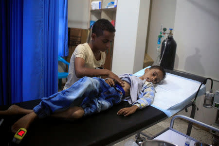 A relative of malnourished Ghazi Ahmad, 10, checks him at a hospital in Taiz, Yemen November 3, 2018. Picture taken November 3, 2018. REUTERS/Anees Mahyoub