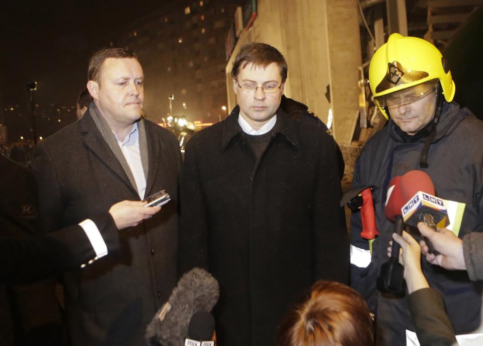 Latvia's Interior Minister Kozlovskis and PM Dombrovskis speak to the media near the collapsed Maxima supermarket in Riga