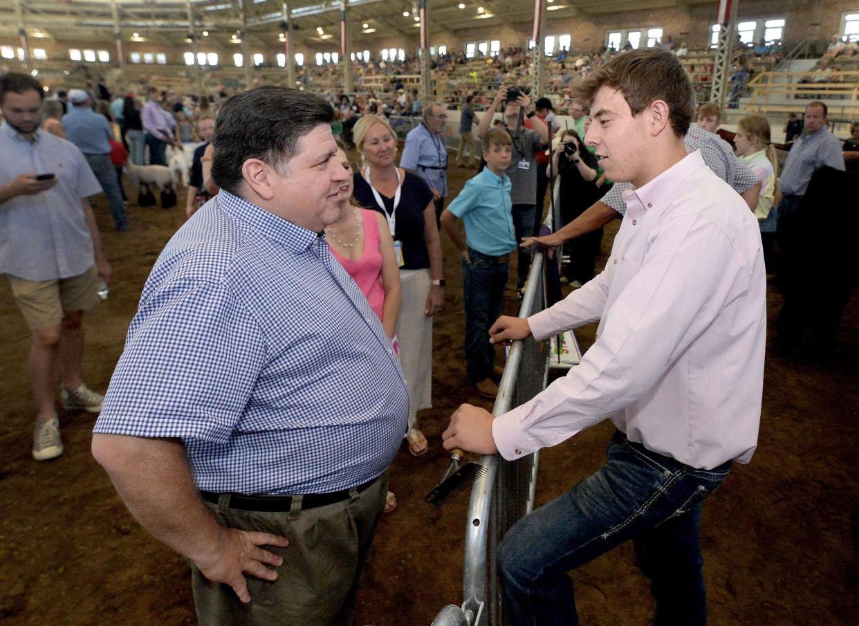 Gov. JB Pritzker, left, talks with Kashen Ellerbrock, 16, of Atkinson at the Governor's Sale of Champions at the Illinois State Fair on Wednesday, August 16, 2023. Ellerbrock raised the grand champion steer, Bill. Pritzker and First Lady MK Pritzker donated $105,000 to purchase the champion steer, which was donated to Feeding Illinois and will be donated to food banks across the state.