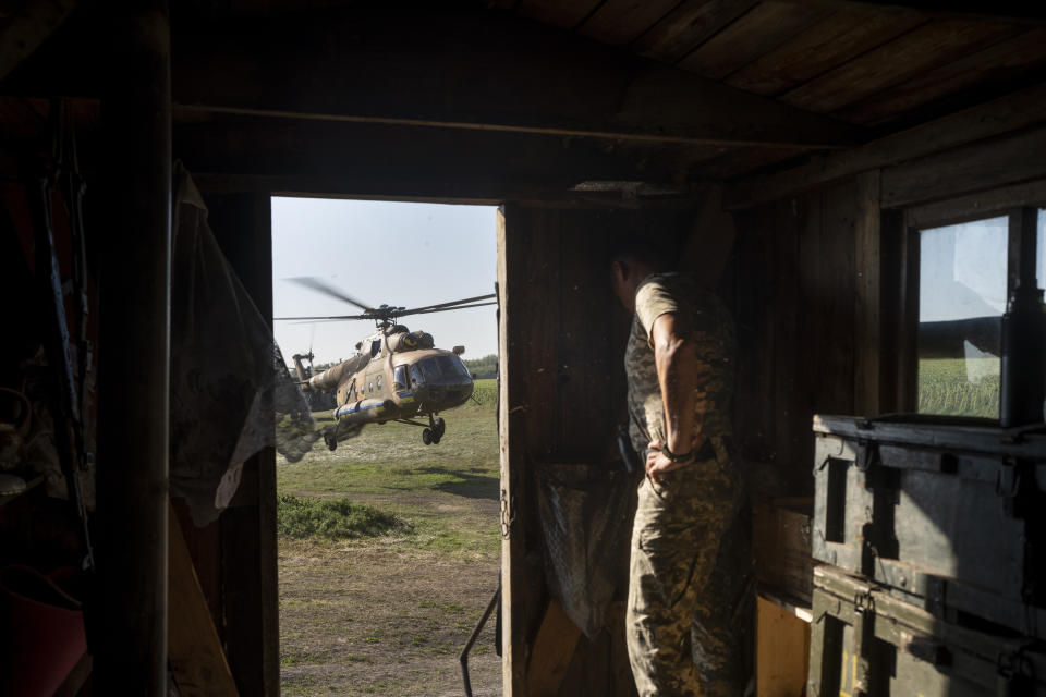 FILE - A Ukrainian soldier hides in a trailer from a landing military helicopter in eastern Ukraine, Friday, Aug. 18, 2023. Moscow’s army is staging a ferocious push in northeast Ukraine designed to distract Ukrainian forces from their counteroffensive and minimize the number of troops Kyiv is able to send to more important battles in the south. (AP Photo/Bram Janssen, File)