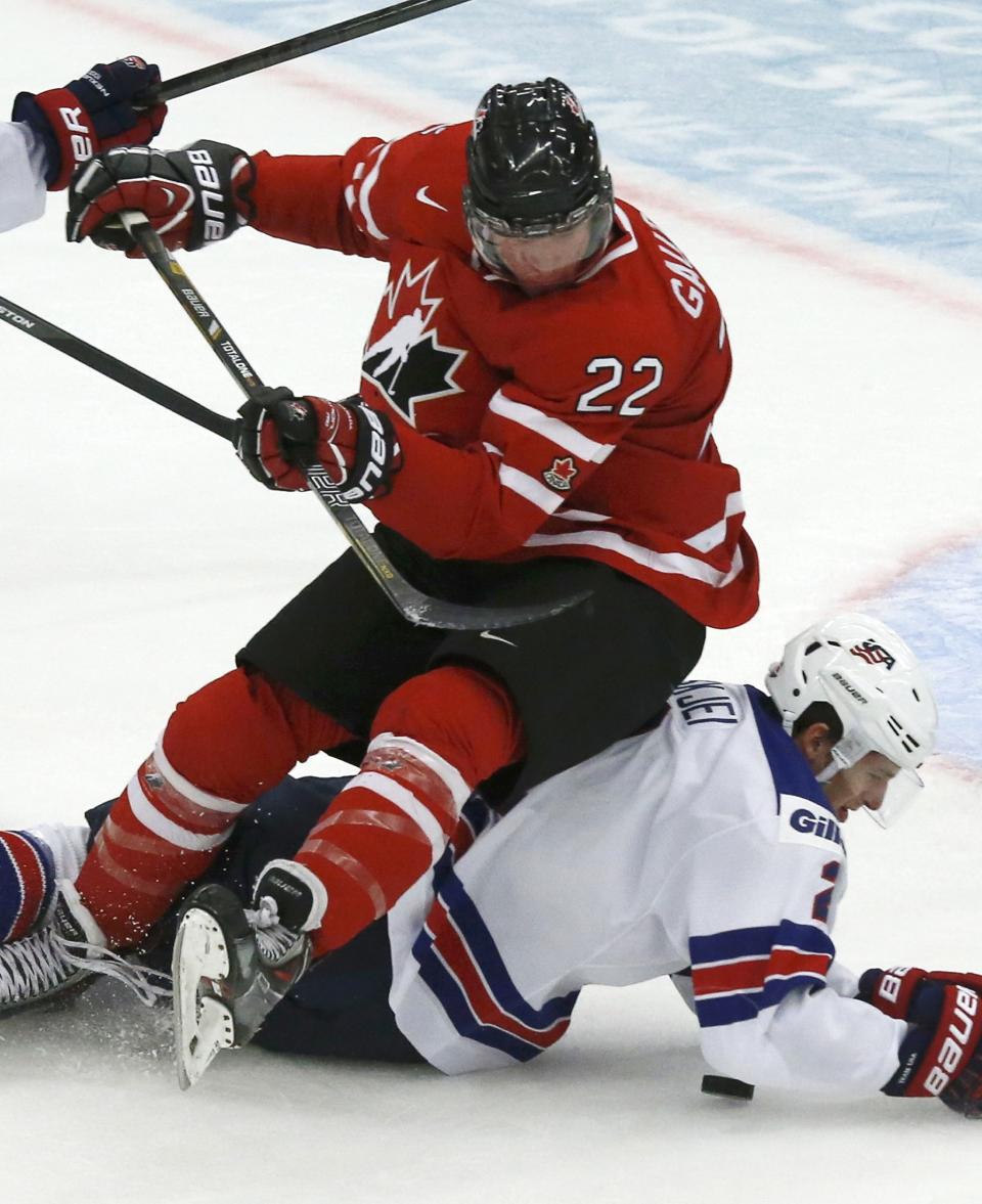 Canada's Gauthier falls on United States' Skjei during the first period of their IIHF World Junior Championship ice hockey game in Malmo