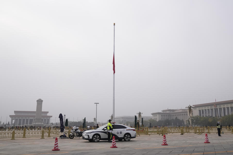 Policemen stand guard as a Chinese flag is flown at half-staff at Tiananmen Square to mourn the death of former Premier Li Keqiang, in Beijing Thursday, Nov. 2, 2023. Hundreds, possibly thousands, of people gathered near a state funeral home Thursday as former Premier Li Keqiang was being put to rest. (AP Photo/Andy Wong)