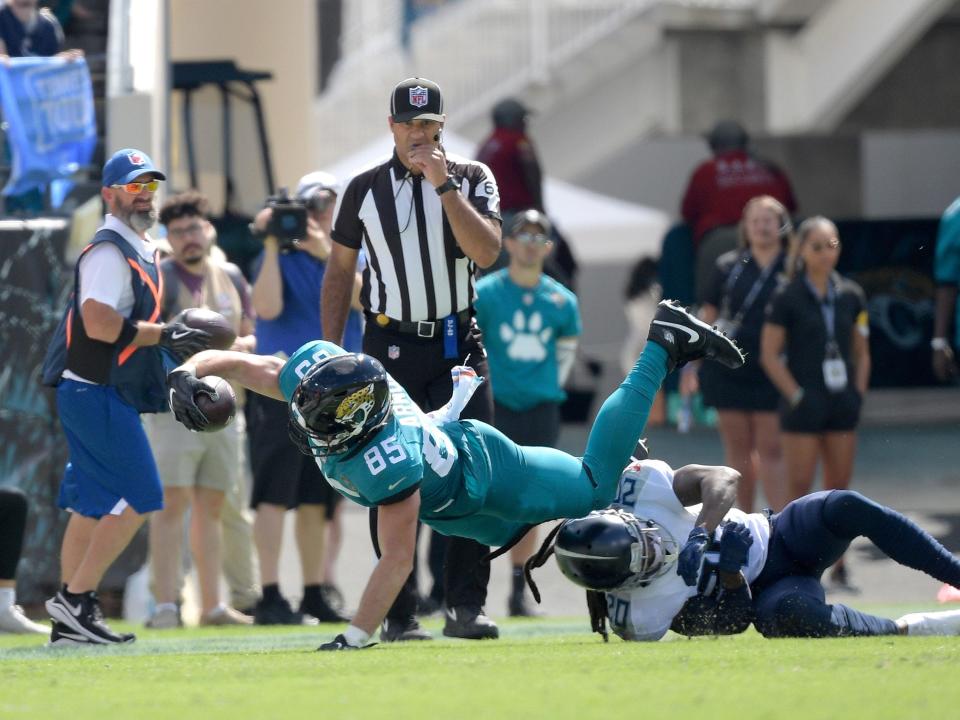 Dan Arnold leaps forward against the Tennessee Titans.