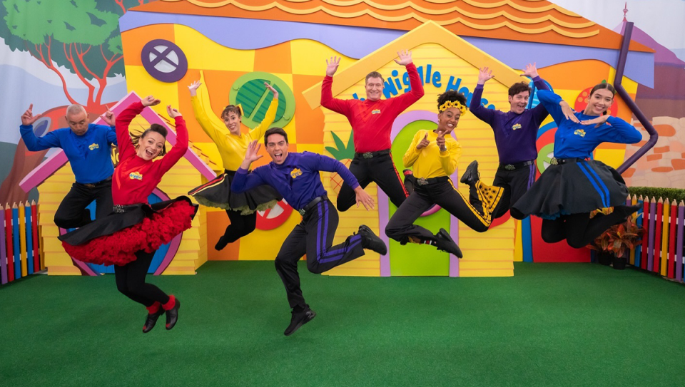 The Wiggles jumping in the air.