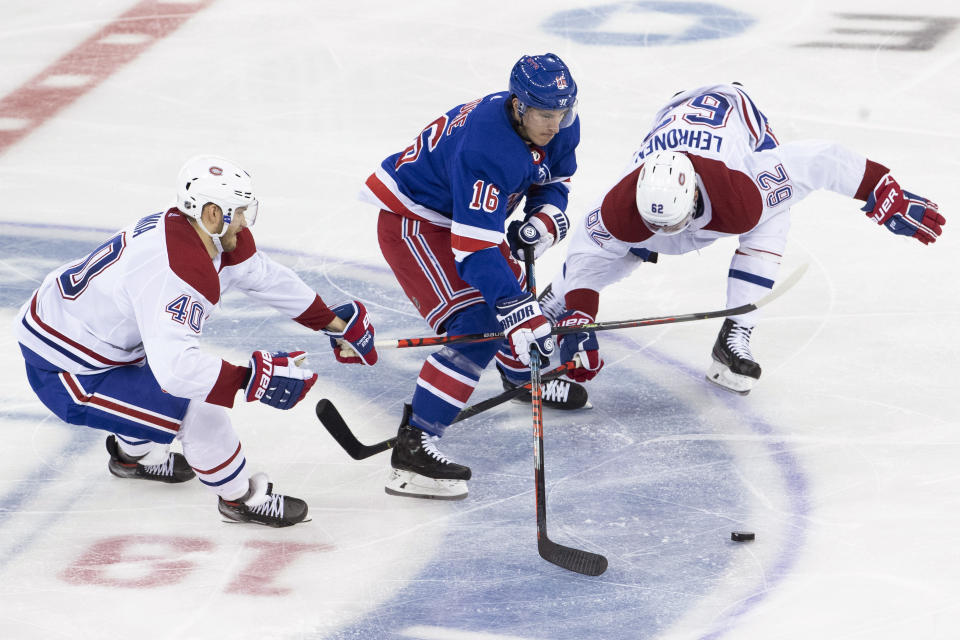 New York Rangers center Ryan Strome (16) skates between Montreal Canadiens right wing Joel Armia (40) and left wing Artturi Lehkonen (62) during the third period of an NHL hockey game Friday, Dec. 6, 2019, at Madison Square Garden in New York. The Canadiens won 2-1. (AP Photo/Mary Altaffer)