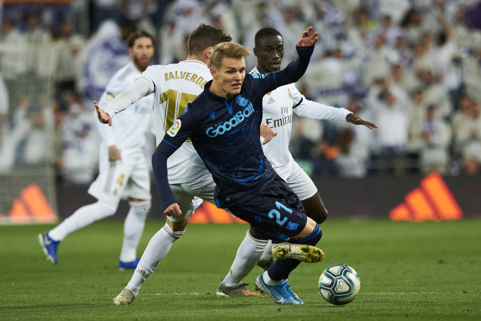 MADRID, SPAIN - NOVEMBER 23: Midfielder Martin Odegaard of Real Sociedad gets tackled by Midfielder Federico Valverde of Real Madrid CF during the Liga match between Real Madrid CF and Real Sociedad at Estadio Santiago Bernabeu on November 23, 2019 in Madrid, Spain. (Photo by Xaume Olleros/Getty Images)