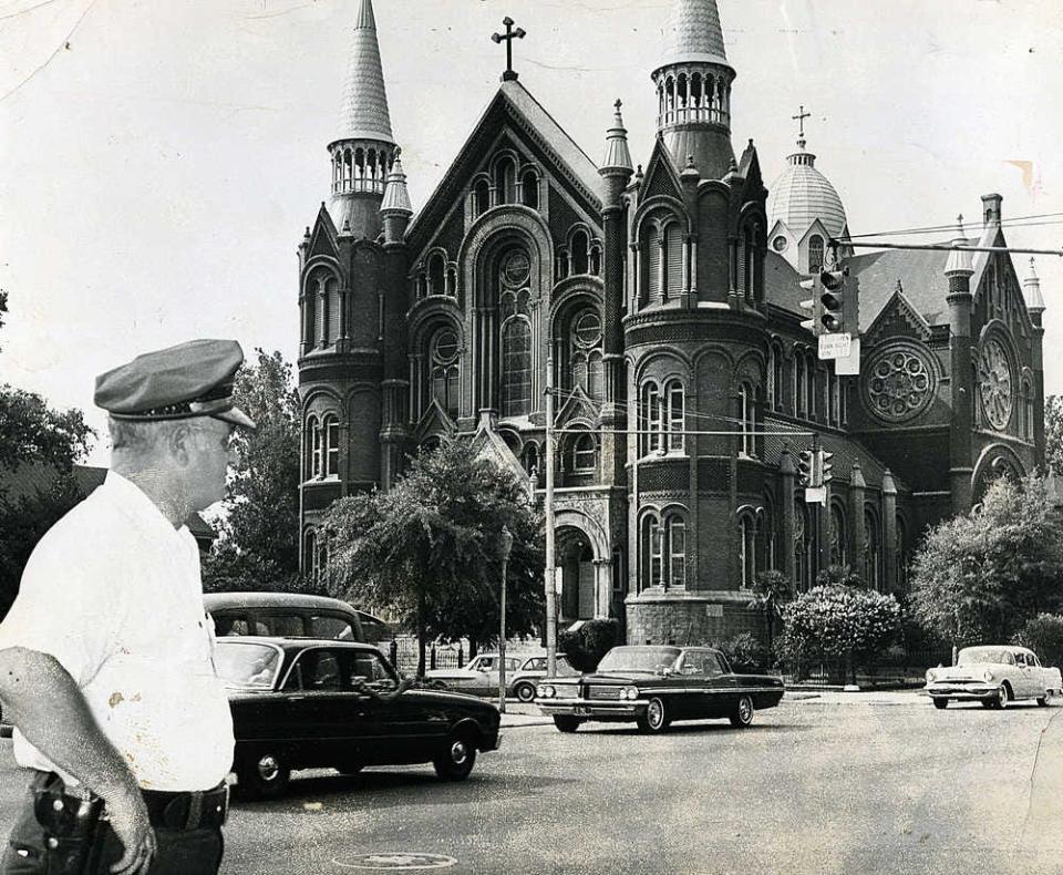 FILE - A police officer watches traffic outside Augusta's Sacred Heart Church in the early 1960s. Within the next decade, it would be marked for demolition, until it was saved by concerned citizens.