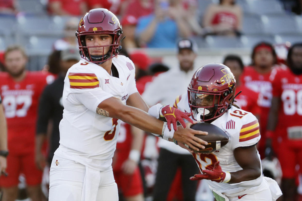 Iowa State quarterback Rocco Becht, left, hands off to running back Jaylon Jackson (12) during the first half of an NCAA college football game against Houston, Saturday, Sept. 28, 2024, in Houston. (AP Photo/Michael Wyke)