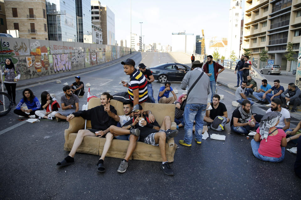 Anti-government protesters block a main highway in Beirut, Lebanon, Wednesday, Nov. 13, 2019. A local official for a Lebanese political party was shot dead by soldiers trying to open a road closed by protesters in southern Beirut late Tuesday, the army reported, marking the first death in 27 days of nationwide protests. (AP Photo/Bilal Hussein)