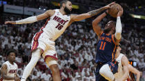 Miami Heat forward Caleb Martin (16) attempts to block a shot from New York Knicks guard Jalen Brunson (11) during the first half of Game 3 of an NBA basketball second-round playoff series, Saturday, May 6, 2023, in Miami. (AP Photo/Wilfredo Lee)