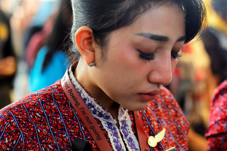 A colleague of the crew of Lion Air flight JT610 cries on the deck of Indonesian Navy ship KRI Banjarmasin as they visit the site of the crash to pay their tribute, off the north coast of Karawang, Indonesia, November 6, 2018. REUTERS/Beawiharta/Files