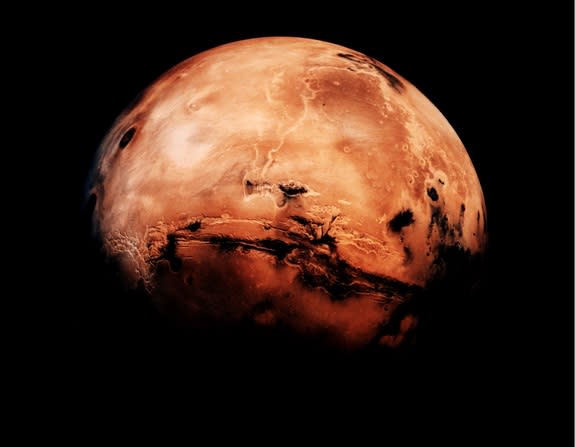 The northern hemisphere of Mars is marked by vast sandy plains, made up partly of red iron oxides. The jagged Valles Marineris canyon near the equator is nearly five miles deep and almost as wide as the United States.