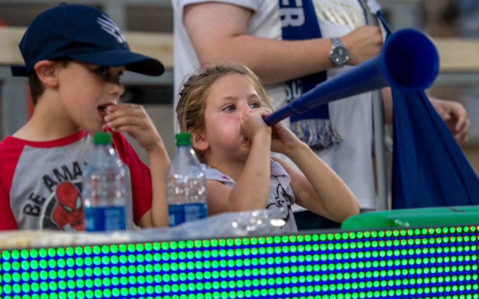 A young Northern Colorado Hailstorm FC fan blows into a vuvuvzela in the first half of a match against Forward Madison FC at Canvas Stadium on Tuesday.