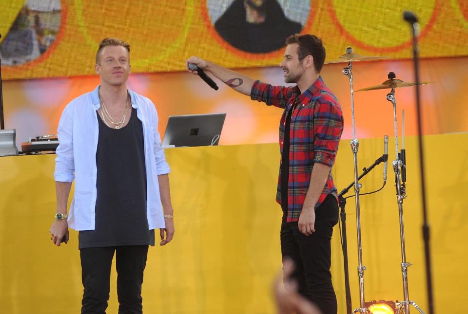 FILE - In this Aug. 16, 2013 file photo, musician Ben Haggerty, also known as Macklemore, left, and Ryan Lewis perform on stage at the Good Morning America Concert Series at Central Park's Rumsey Playfield in New York City. Macklemore & Ryan Lewis are top contenders at the Jan. 26, 2014, Grammy Awards, with seven nominations, including best new artist and song of the year for “Same Love.” Their debut album, “The Heist,” is up for album of the year and best rap album, while the massive hit “Thrift Shop” is nominated for best rap song and rap performance. The duo’s other hit, “Can’t Hold Us,” will compete for best music video. (Photo by Brad Barket/Invision/AP, File)