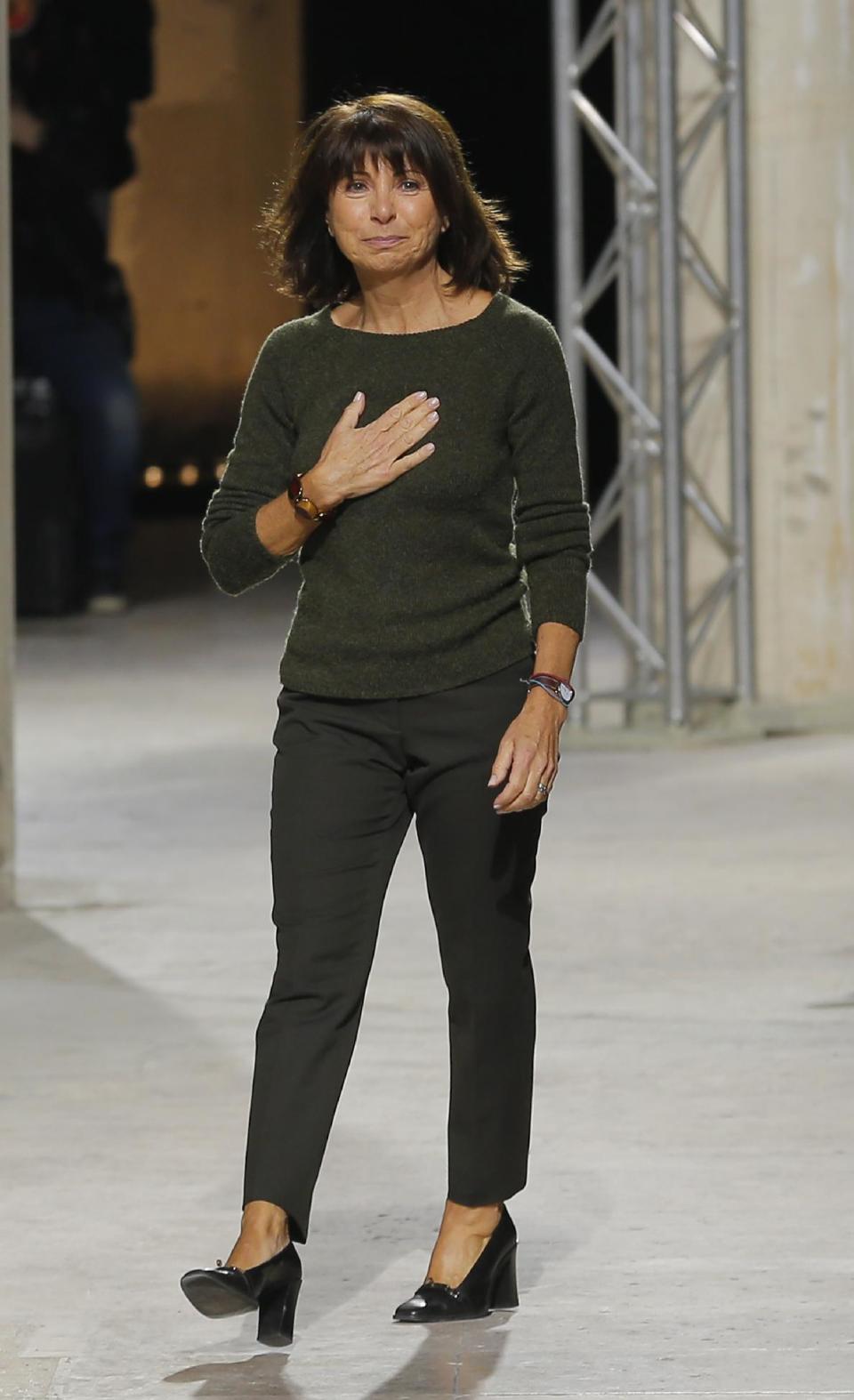 French fashion designer Veronique Nichanian reacts at the end of her Men's fall-winter 2013-2014 fashion collection presented in Paris, Saturday Jan. 19, 2013. (AP Photo/Jacques Brinon)