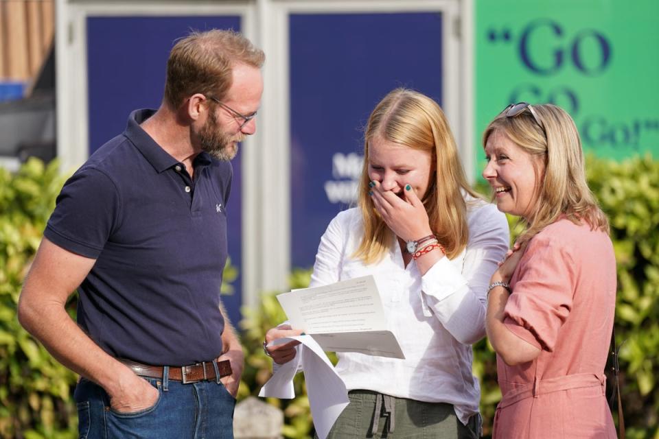 A student reacts after reading their A-level results at Norwich School (PA Wire)