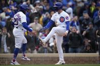 Chicago Cubs second baseman Nico Hoerner celebrates with Cubs' Miles Mastrobuoni after scoring on a single by Chicago Cubs shortstop Dansby Swanson during the third inning of a baseball game against the Milwaukee Brewers Thursday, March 30, 2023, in Chicago. (AP Photo/Erin Hooley)