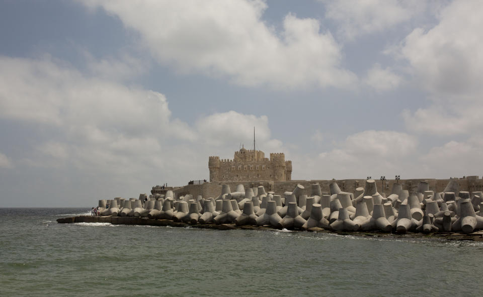 In this Aug. 8, 2019 photo, cement barriers reinforce the sea wall near the citadel in Alexandria, Egypt. Alexandria, which has survived invasions, fires and earthquakes since it was founded by Alexander the Great more than 2,000 years ago, now faces a new menace from climate change. Rising sea levels threaten to inundate poorer neighborhoods and archaeological sites, prompting authorities to erect concrete barriers out at sea to hold back the surging waves. (AP Photo/Maya Alleruzzo)