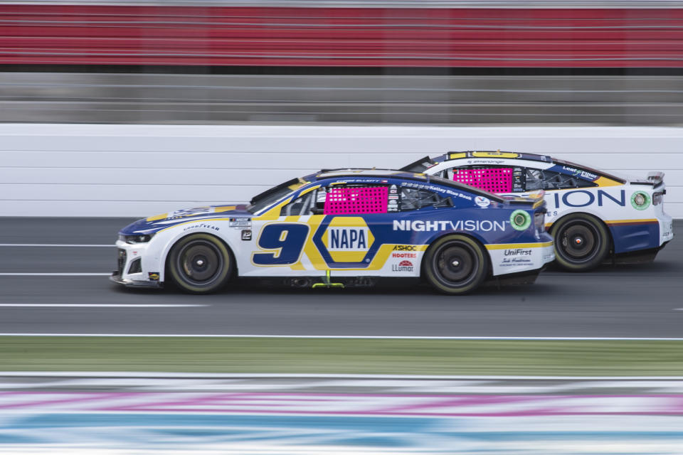 Chase Elliott (9) passes AJ Allmendinger during a NASCAR Cup Series auto race at Charlotte Motor Speedway, Sunday, Oct. 9, 2022, in Concord, N.C. (AP Photo/Matt Kelley)