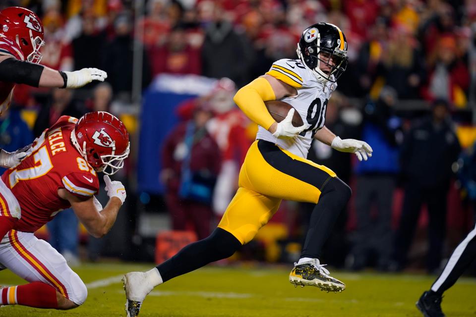 Pittsburgh Steelers outside linebacker T.J. Watt runs from Kansas City Chiefs tight end Travis Kelce (87) while returning a fumble for a touchdown during the first half of an NFL wild-card playoff football game on Sunday, Jan. 16, 2022.