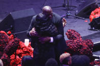 Former Los Angeles Lakers' Magic Johnson hugs Pam Bryant mother of Kobe Bryant during a celebration of life for Kobe Bryant and his daughter Gianna Monday, Feb. 24, 2020, in Los Angeles. (AP Photo/Marcio Jose Sanchez)