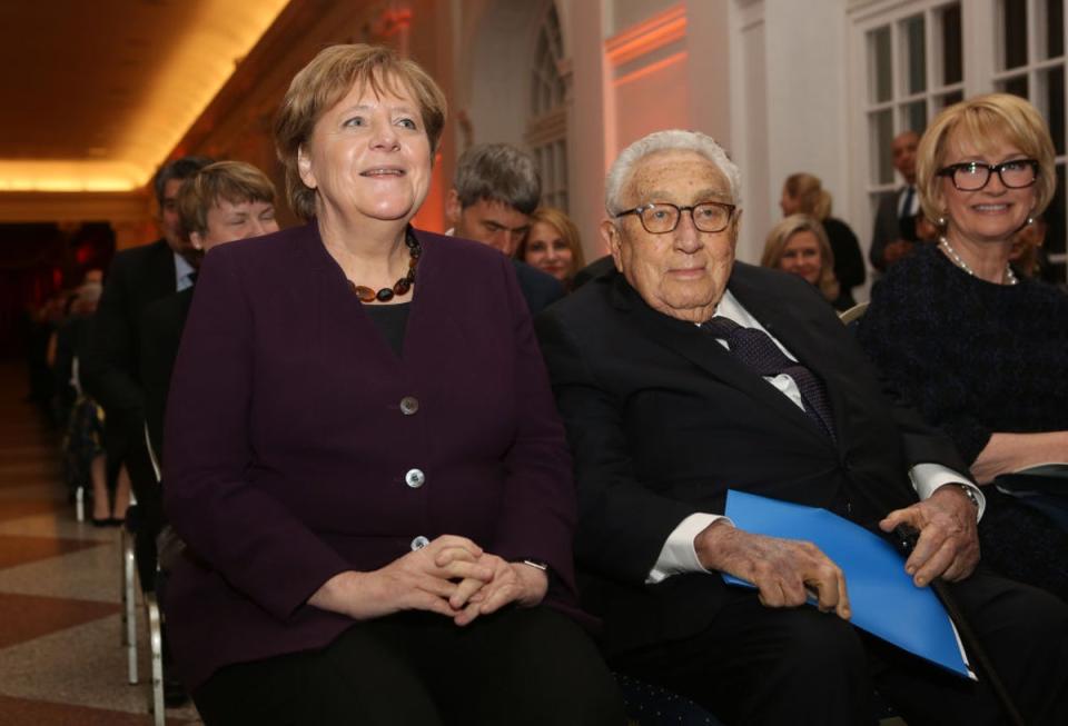 German Chancellor Angela Merkel, left, and Henry A. Kissinger, right, former US Sectretary of State, arrive for the award ceremony for the Henry A. Kissinger Prize 2020 at the Charlottenburg palace in Berlin, Germany, 21 January 2020 (Getty Images)