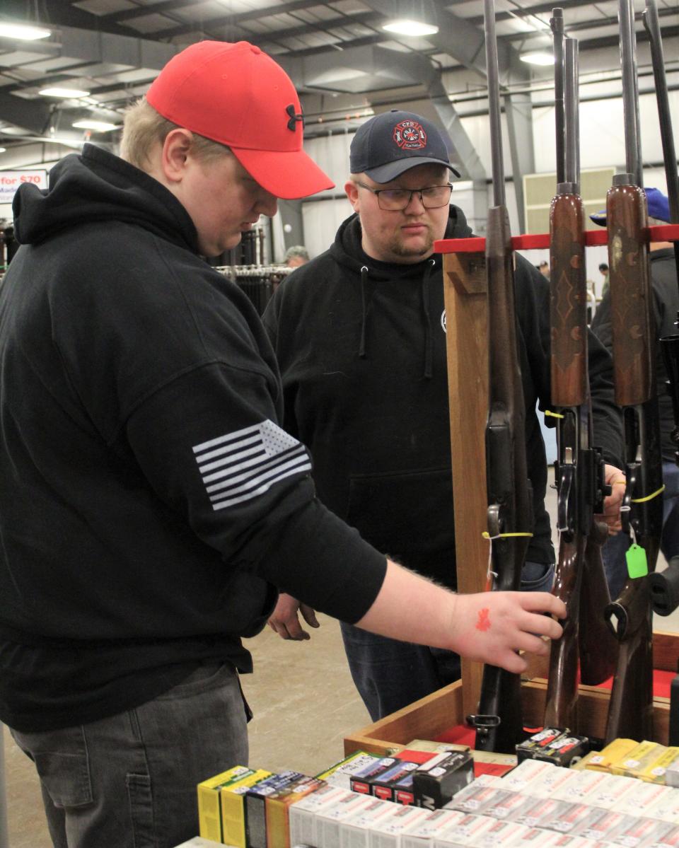 Gun enthusiasts Kedrick Johnson (left) and Joseph Schafer traveled from Wayne County to attend the show and possibly add to their gun collections. Provided by Kennedy Bowling