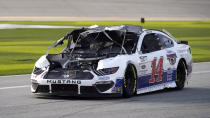 Chase Briscoe (14) drives down pit road to repair damage to his car after he was in a crash during the NASCAR Cup Series road course auto race at Daytona International Speedway, Sunday, Feb. 21, 2021, in Daytona Beach, Fla. (AP Photo/John Raoux)