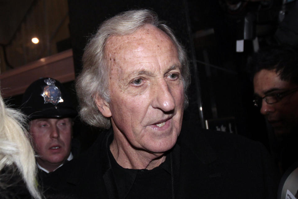 FILE - Journalist John Pilger, one of the supporters of the Wikileaks website founder Julian Assange, talks to media outside the City of Westminster Magistrates Court in central London, following Assange bail hearing, Tuesday, Dec. 14, 2010. John Pilger, the Australia-born journalist and documentary maker known for his coverage of the Khmer Rouge in Cambodia, has died. He was 84. (AP Photo/Lefteris Pitarakis, File)